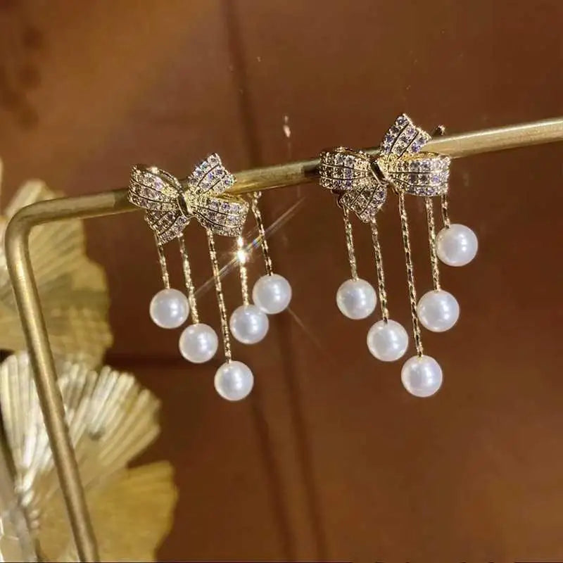 Paved Bow Pearl Tassel Earrings in Zinc Alloy