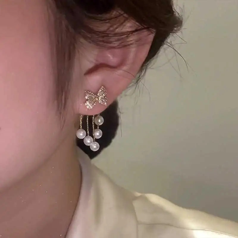 Paved Bow Pearl Tassel Earrings in Zinc Alloy